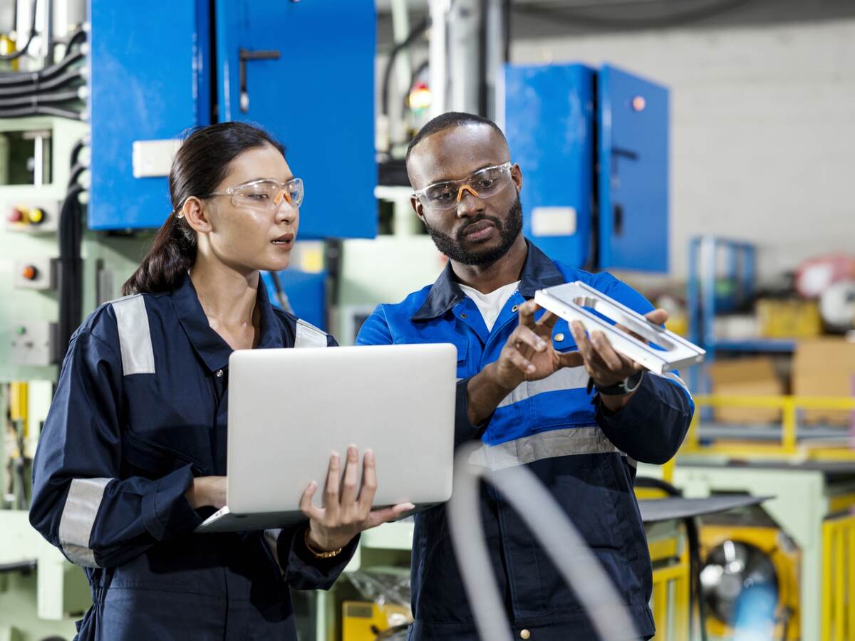 Two people looking over a device.